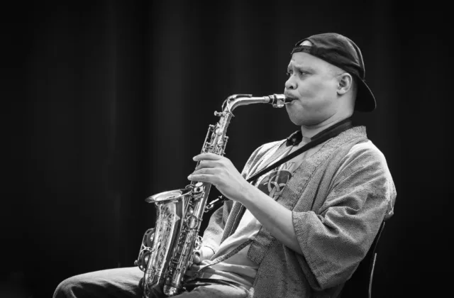 Black-and-white portrait of Steve Coleman playing alto saxophone at the Kimmel Center.